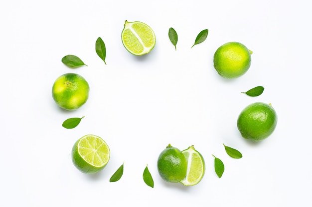 Limes with leaves isolated on white.