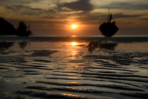 Line of beach sand with sunset time low and dark lighting.