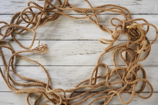 Linen rope on a wooden background top view