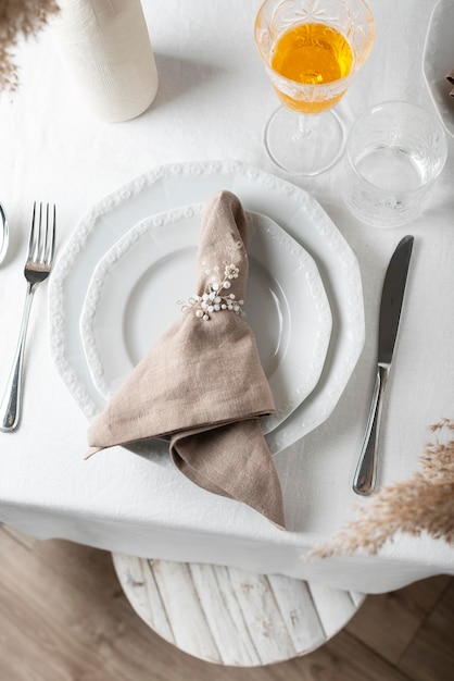 Linen white tablecloth and beige napkin