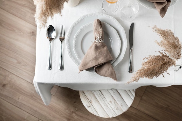 Linen white tablecloth and beige napkin