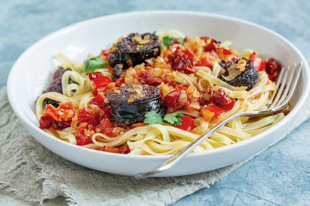 Linguine pasta with tomato sauce and blood sausage