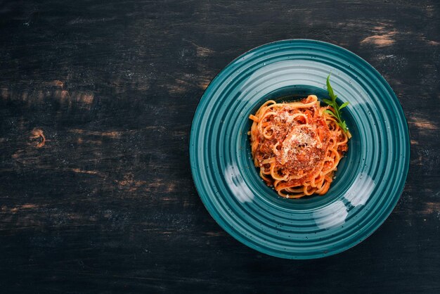 Linguine Pasta with tomatoes On a wooden background Italian cuisine Top view Copy space