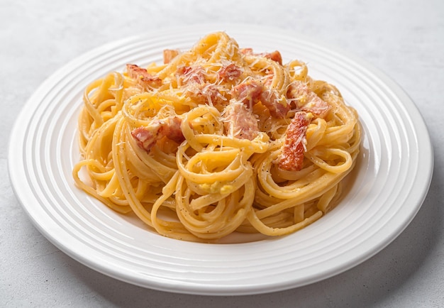 Linguini pasta with classic Italian carbonara sauce Side view closeup