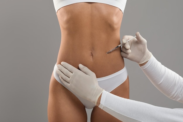 Photo lipolysis concept young woman in underwear getting beauty injection for slimming