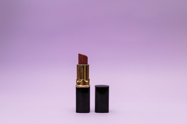 Lipstick in a bottle on a purple background