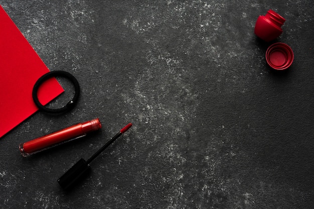 Lipstick and lip balm on a black background