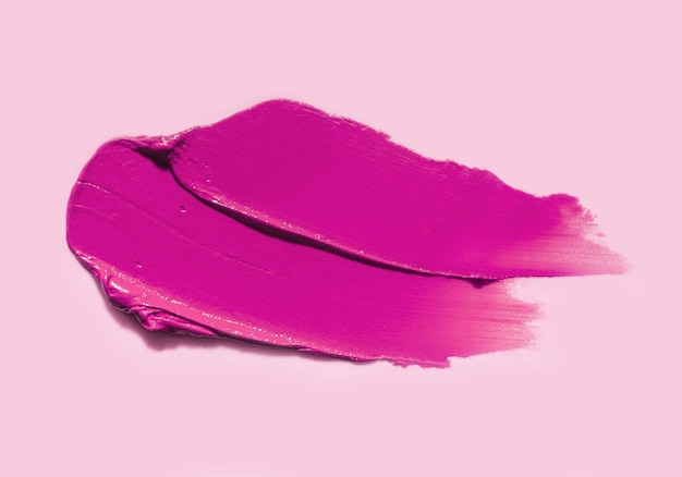 Lipstick pink fuchsia smudge texture isolated on pink background