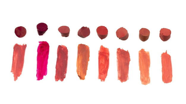 Lipstick swatches isolated on white background. Top view.