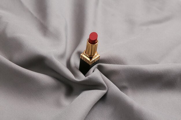 Lipsticks on gray silk background Beauty and fashion still life