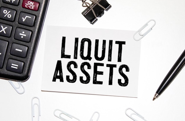 Photo liquid assets text on white paper on white background