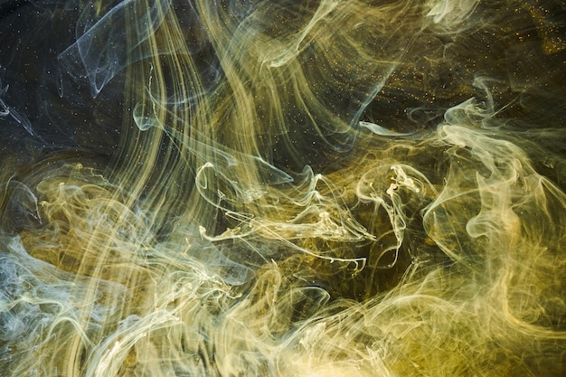 Liquid fluid art abstract background Black yellow dancing acrylic paints underwater space smoke ocean