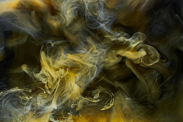 Liquid fluid art abstract background Black yellow dancing acrylic paints underwater space smoke ocean