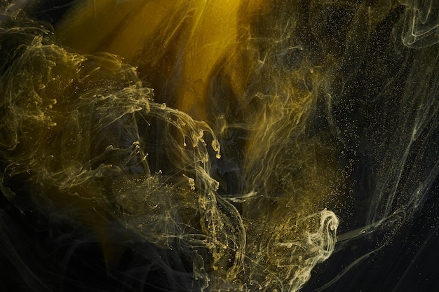 Liquid fluid art abstract background Black yellow dancing acrylic paints underwater space smoke ocean