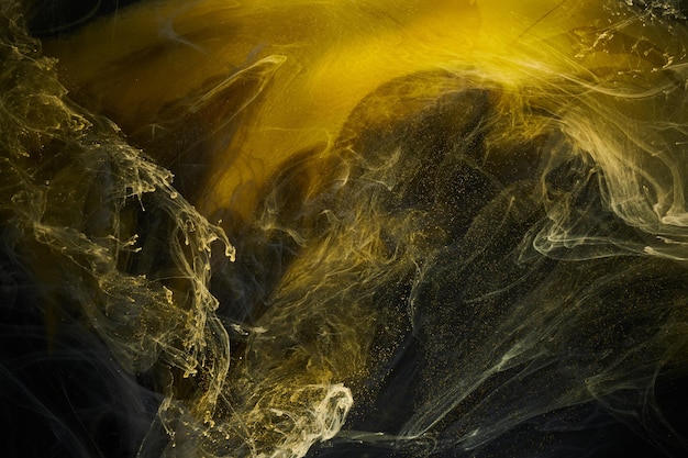 Liquid fluid art abstract background Black yellow dancing acrylic paints underwater space smoke ocean