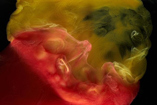 Liquid fluid art abstract background Red yellow dancing acrylic paints underwater space smoke ocean color explosion