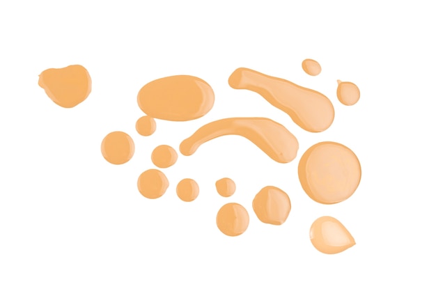 Liquid foundation swatch isolated on white background. Close Up of makeup cream sample.