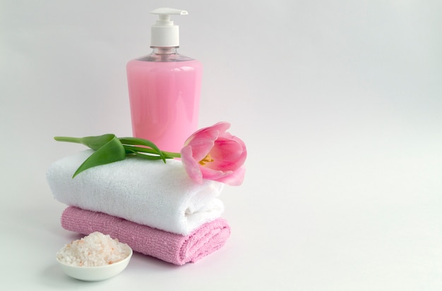 Liquid soap and two towels on a white background.