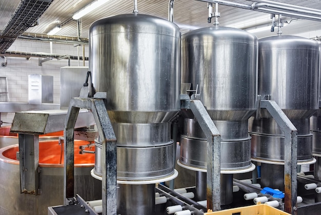 Liquid storage tanks and pipes in the dairy for the production of Gruyere de Comte Cheese in Franche Comte, Burgundy, in France.