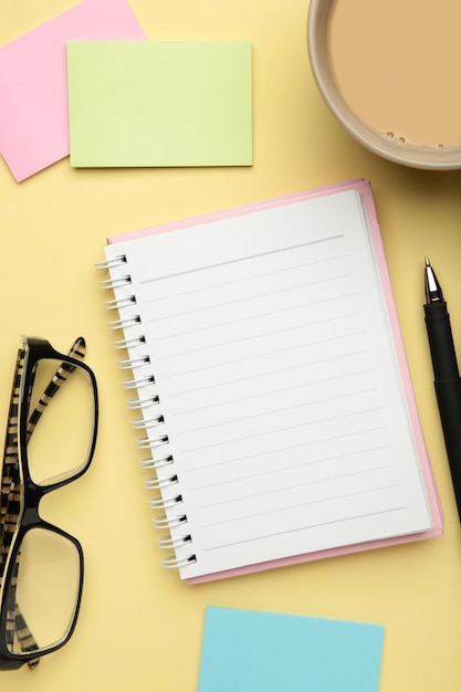 To do list written in a notebook Notebook with an to do list on beige with cup of coffee and clock