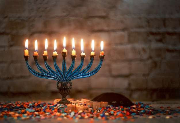 The lit of hanukkah candles in menorah