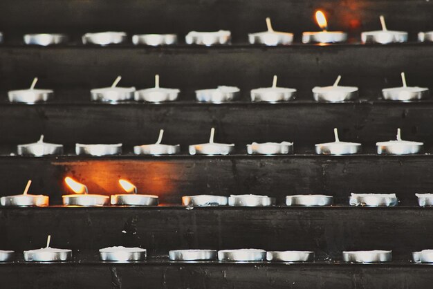 Photo lit tea light candles in shelves