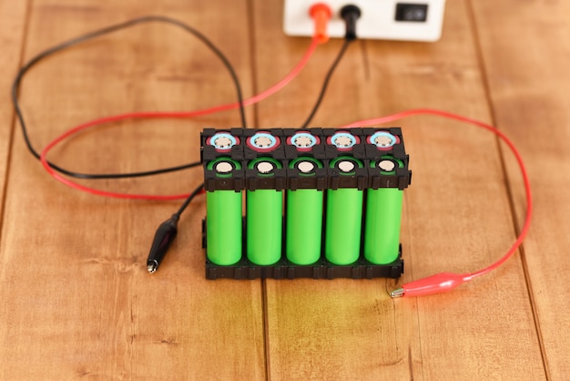 lithium-ion battery holder on the wooden table.