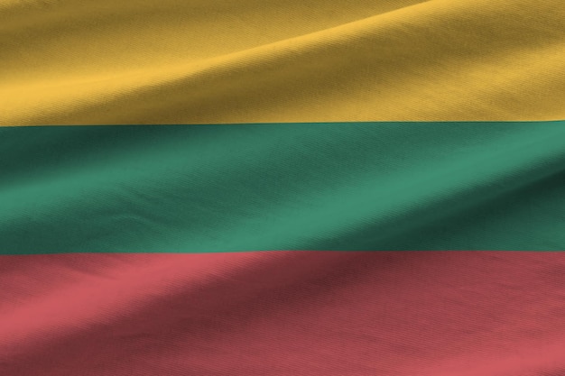 Lithuania flag with big folds waving close up under the studio light indoors The official symbols and colors in banner