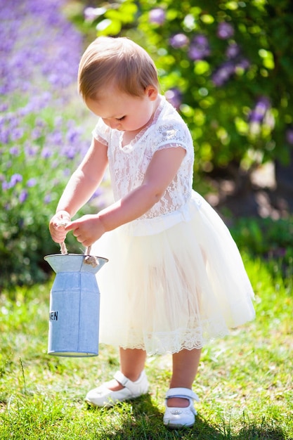 Little adorable baby girl in a lavender field in summer park