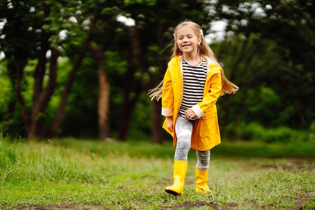 Little adorable girl blowing soap bubbles outdoors in summer park Happy childhood concept