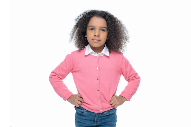 Little african american girl posing in pink cardigan isolated on white