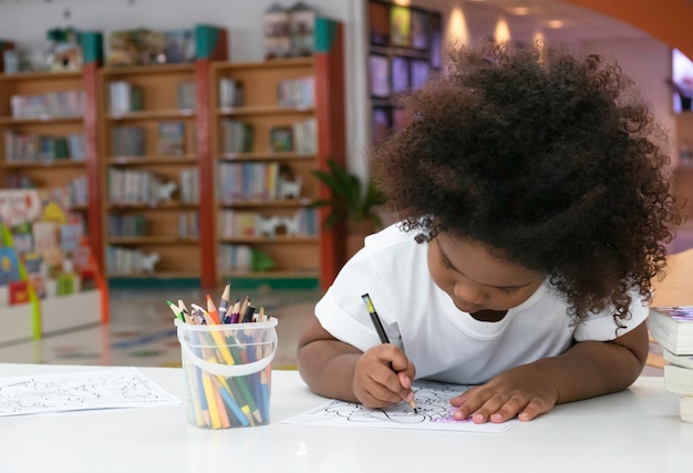 Little African girl painting and drawing with happiness.