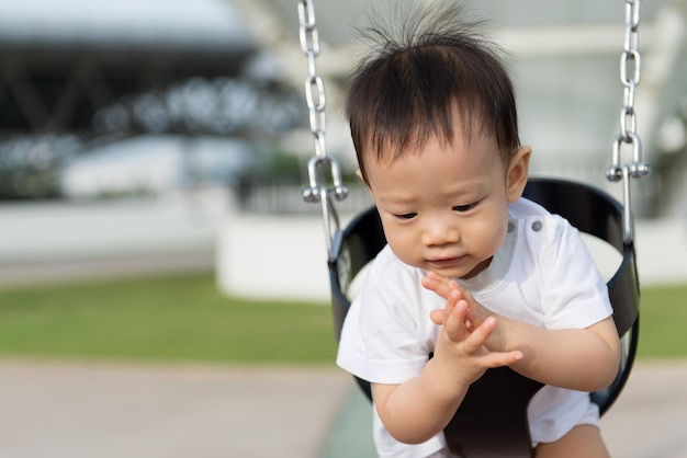 Little Asian boy in swing