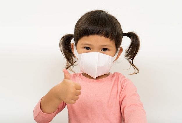 Little asian girl wearing mask for protect