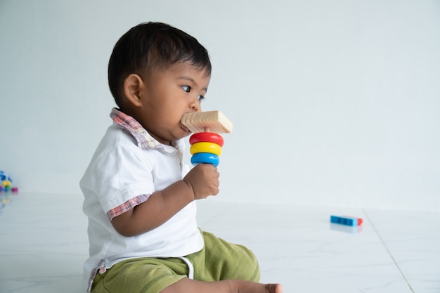 Little baby boy play wooden toy at room