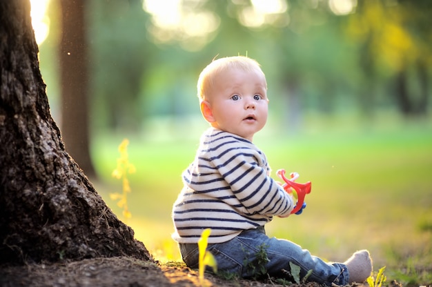 Little baby boy at the sunny park 