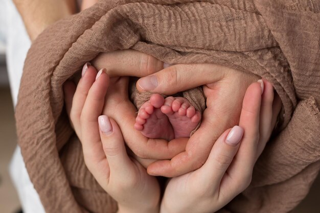 little baby feet in mom's hands. newborn. toes on the background