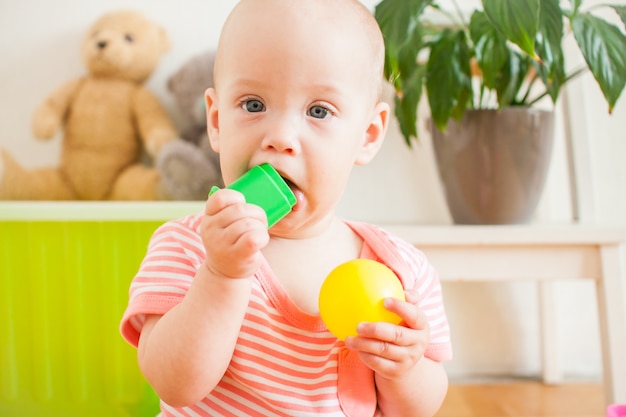 Little baby girl playing with educational toys