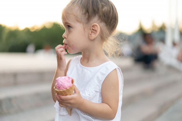 Little beautiful girl eating an ice cream