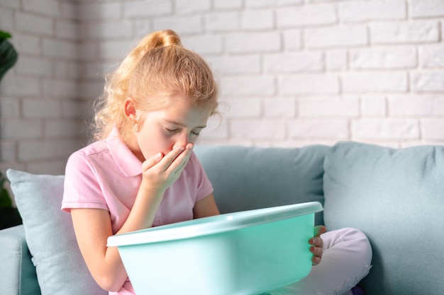 Little blonde girl feeling sick Suffering of nausea vomiting Food poisoning concept