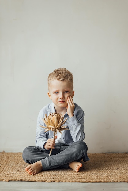 Little boy 4 years old blond in a shirt