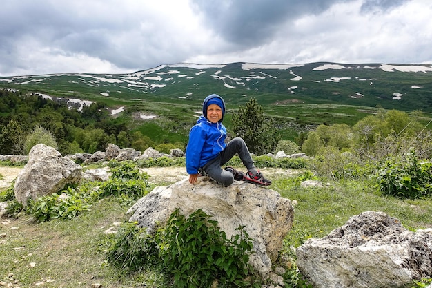 A little boy on the background of the LagoNaki plateau in Adygea Russia