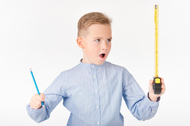 Photo little boy boy can't believe it holds roulette and pencil something is thinking childhood education