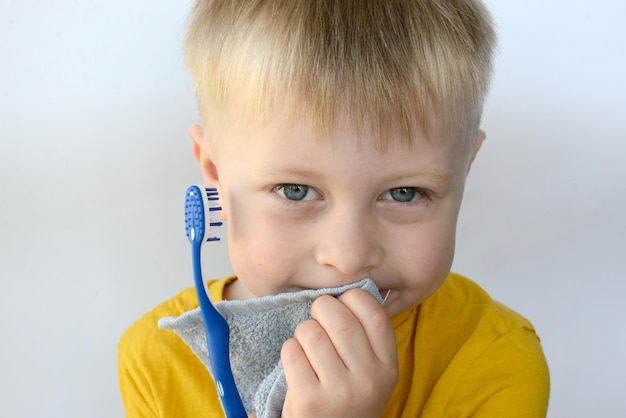 little boy brushing his teeth