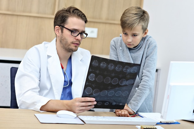 little boy in clinic being examined by pediatrician