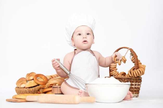 Little boy in a cook cap and with bread funny little chef