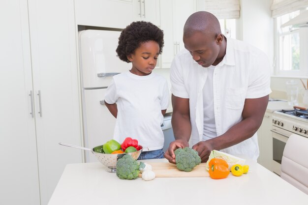 Little boy cooking with his father