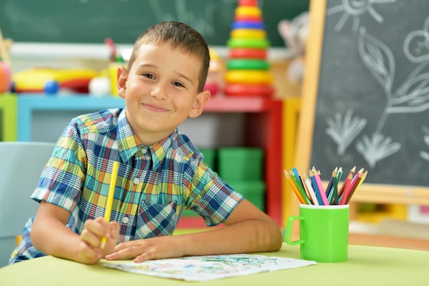 Little boy drawing with pencil