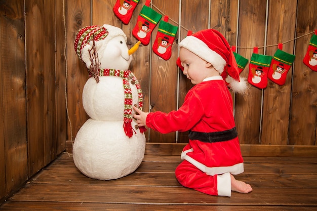 Little boy dressed as Santa Claus