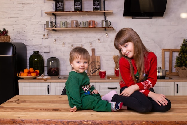 Little boy and girl are having fun in kitchen at home